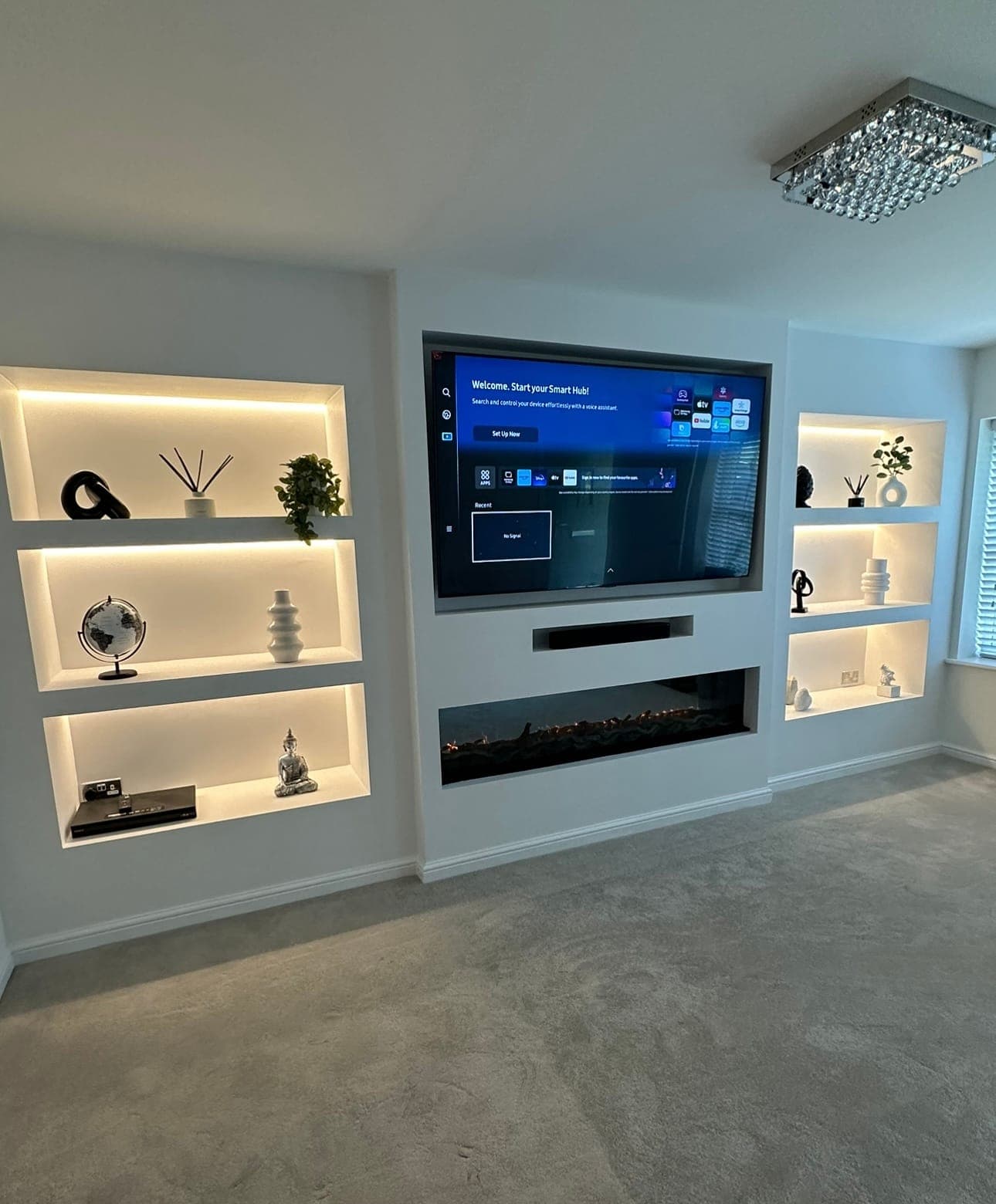 Media Wall Build — Built-in media wall with recessed display shelving, LED lighting and inset electric fire.
