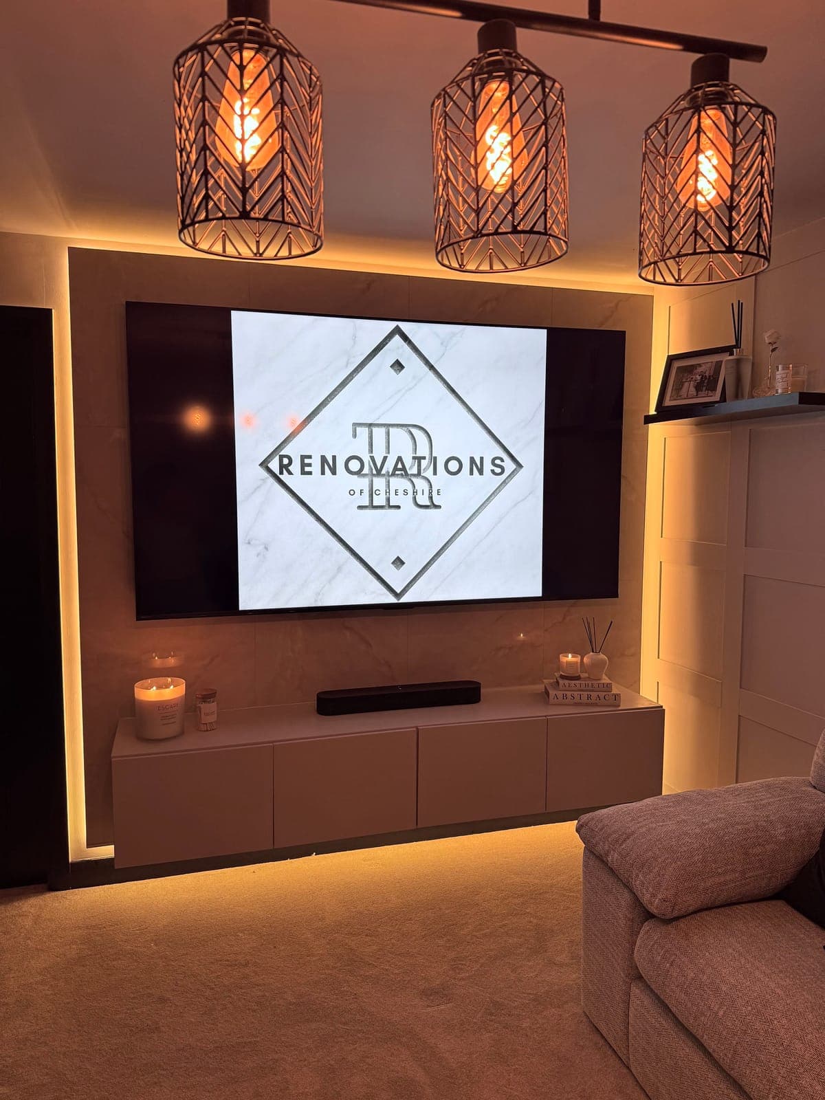 Media Wall & Mood Lighting — Marble-effect media wall with ambient LED backlighting and floating cabinetry.