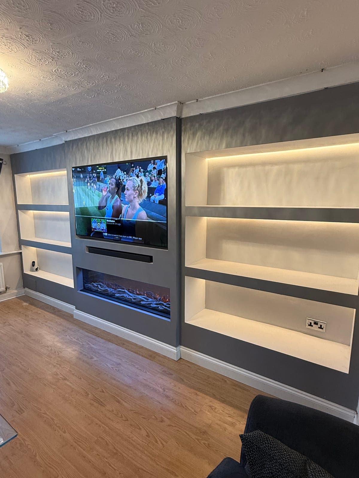 Media Wall & Display Shelving — Full-width media wall with open display shelving and inset electric fire.