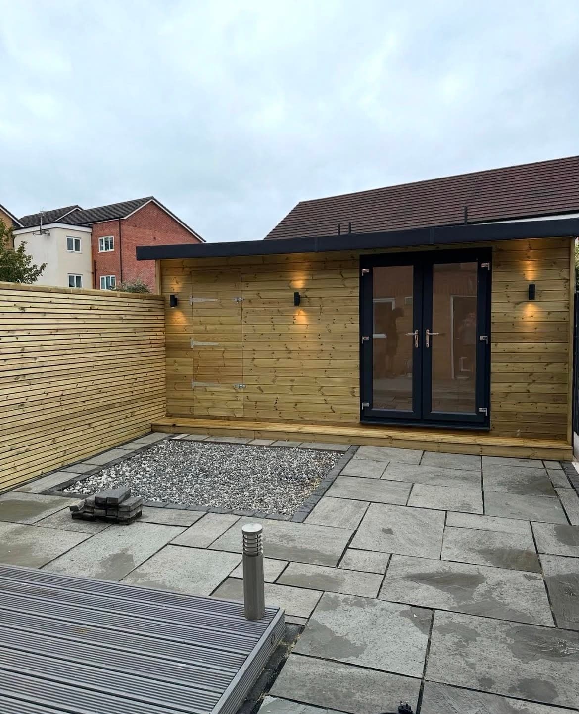 Timber Garden Room — Timber garden room with slate paving, pebbled borders and outdoor lighting.