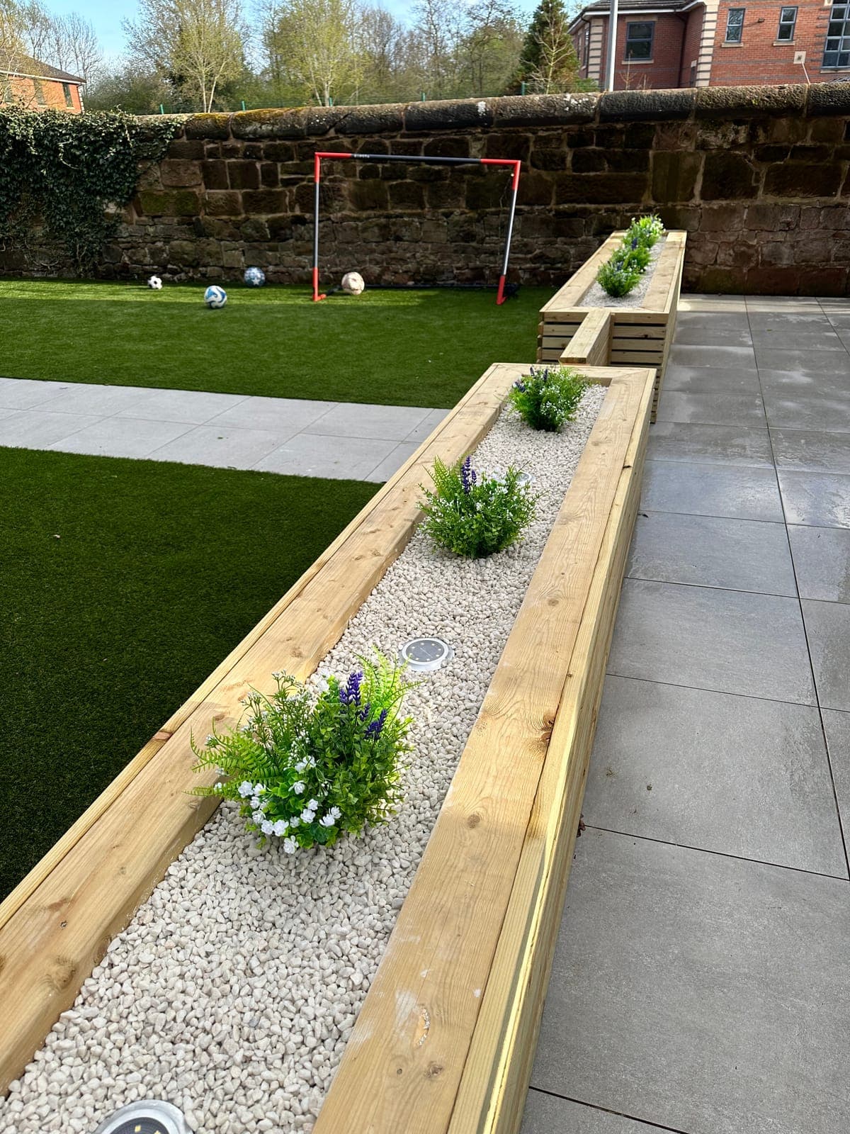 Garden Landscaping — Bespoke timber planters with inset lighting, artificial lawn and porcelain paving.