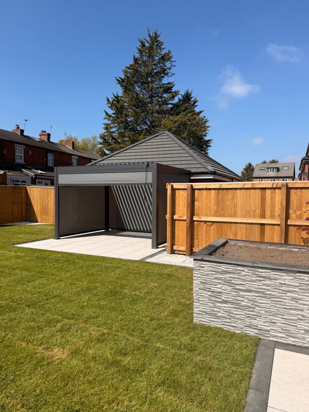 Pergola & Lawn — Louvered pergola alongside a porcelain patio and artificial lawn.